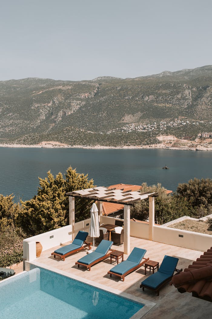 Stunning poolside view from a luxurious villa in Antalya, Turkey, over blue waters.